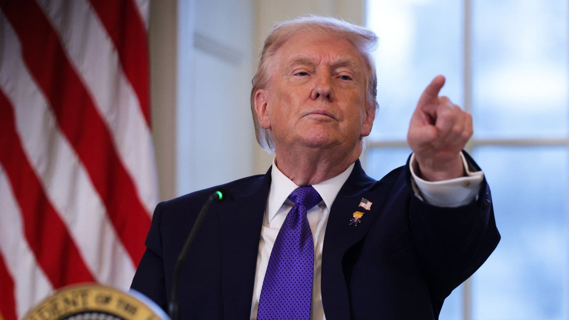 Trump pointing at a reporter for a question