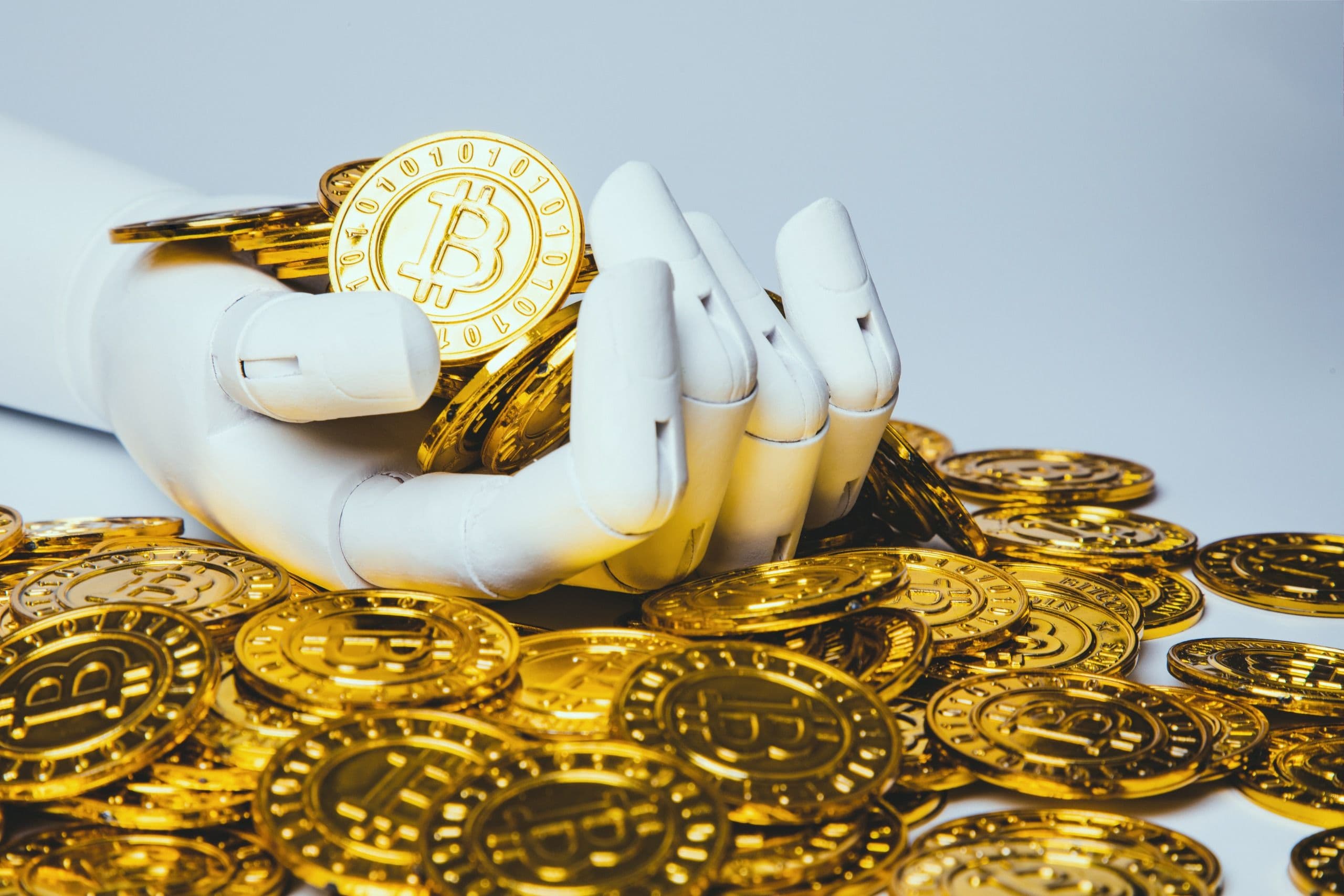 robotic hand holding bitcoin